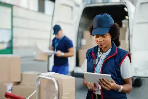 Customs officer reviewing shipping documentation at a border checkpoint